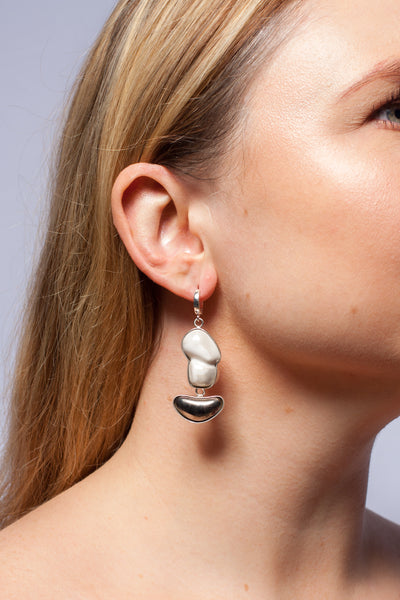 Long white dangle earrings with platinum details drops