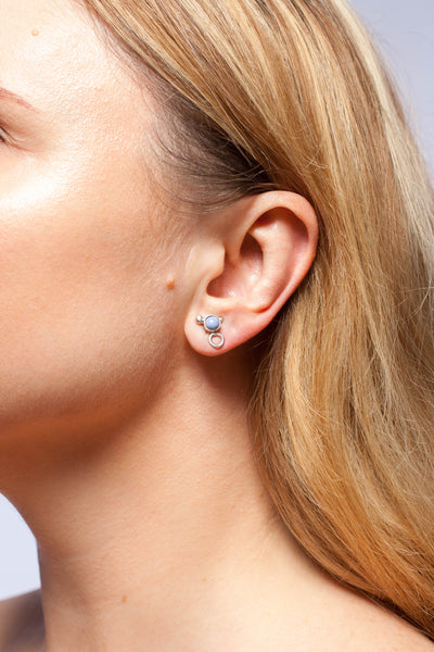 Mismatched silver stud earrings with sky blue ceramic details