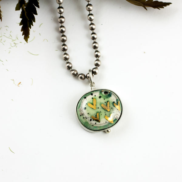 Green pendant with gold luster hearts