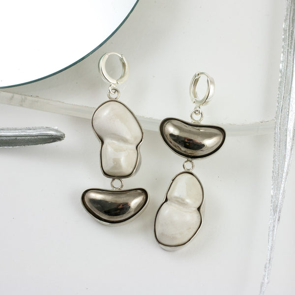 Long white dangle earrings with platinum details drops