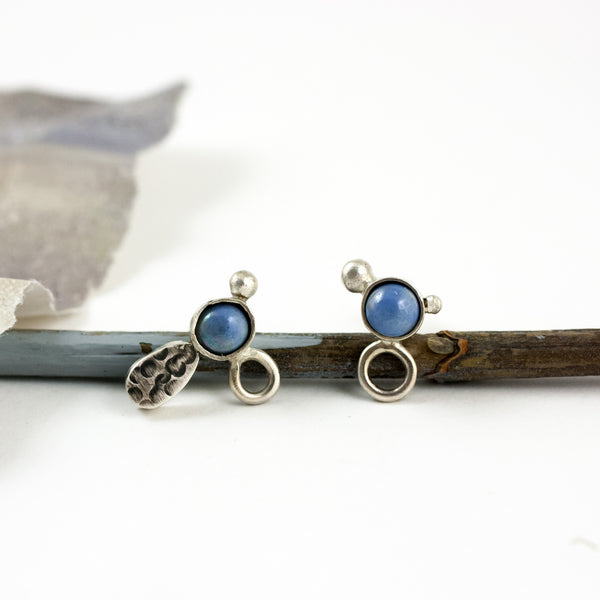 Mismatched silver stud earrings with sky blue ceramic details