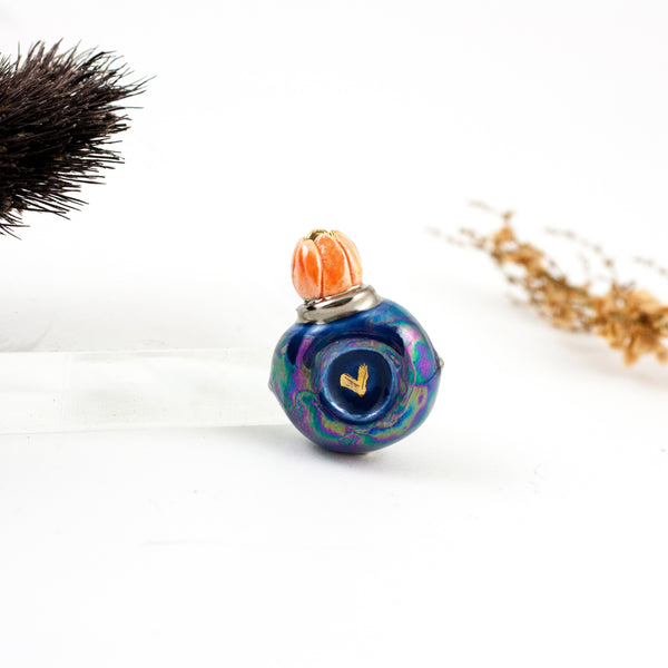 Dark blue flower bud brooch with pearl luster and golden heart