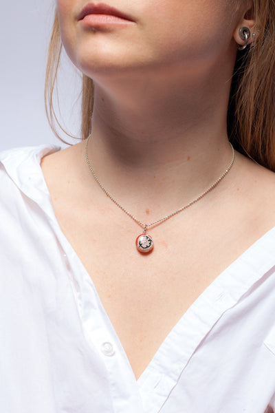 Pink ceramic pendant with a flower and platinum decor