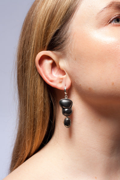 Dangle black mismatched earrings with platinum luster