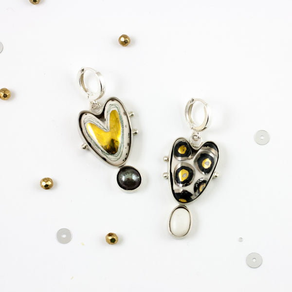 Long mismatched heart shaped silver earrings