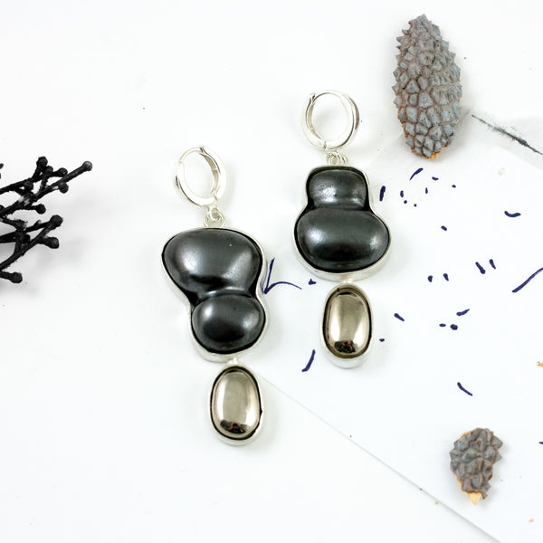Dangle black mismatched earrings with platinum luster