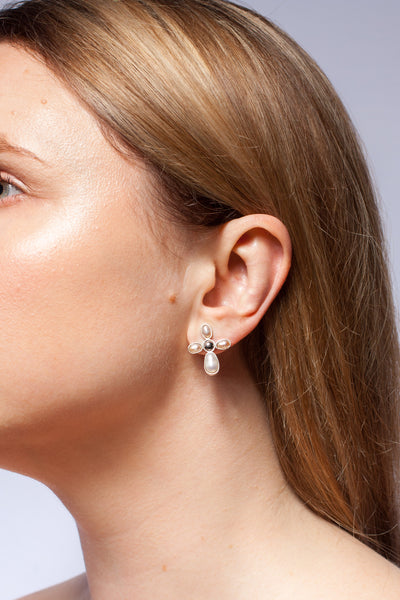Mismatched silver stud earrings with freshwater pearls and ceramics details