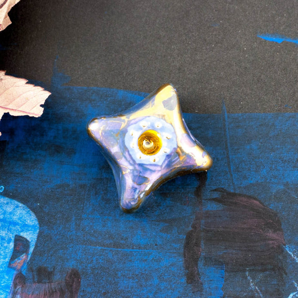 blue brooch with gold center