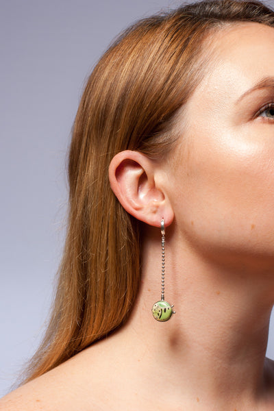Green long dangle earrings with a golden crown