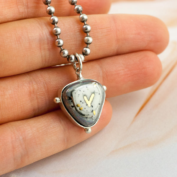 ABSTRACT grey pendant with a gold heart
