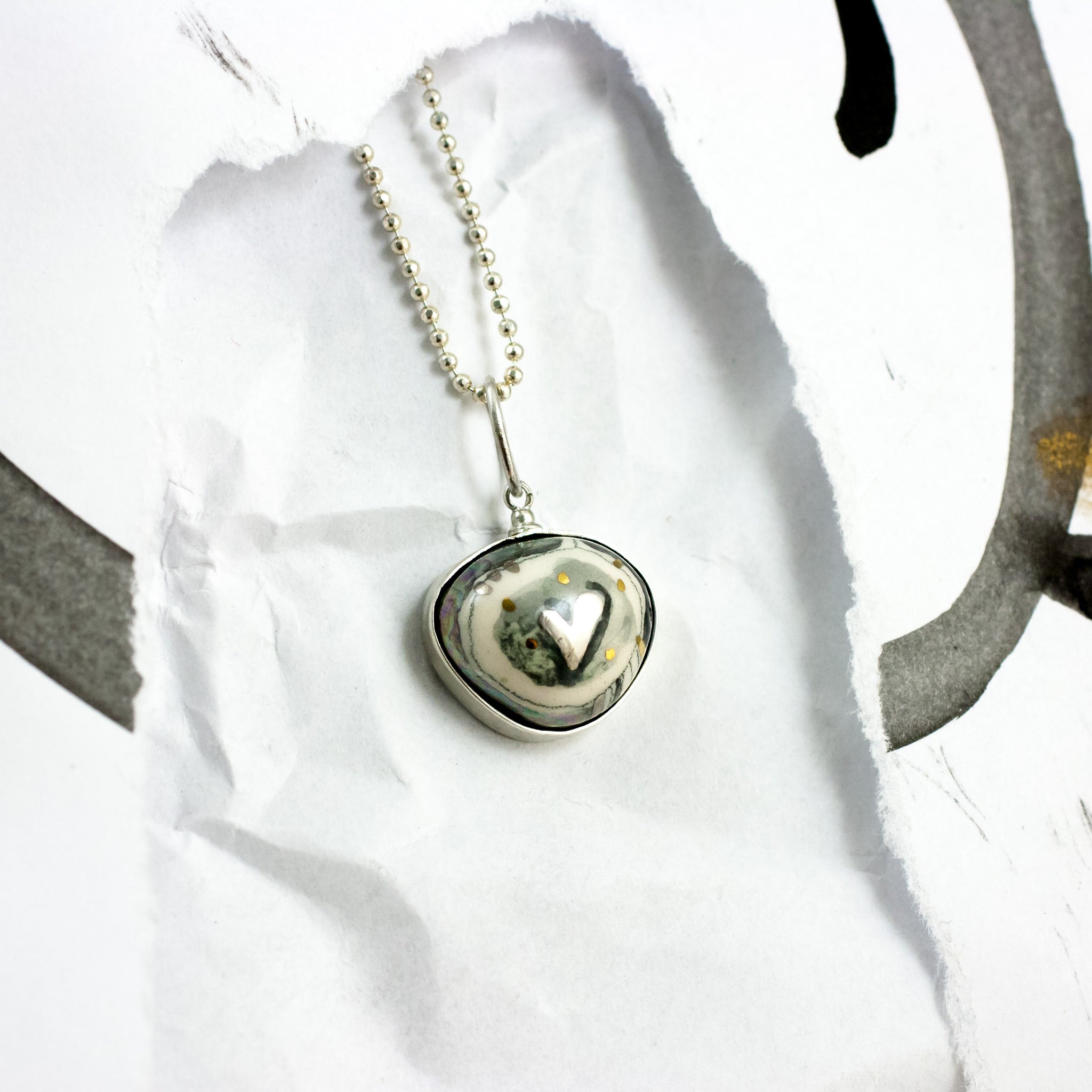 ABSTRACT black and white ceramic pendant with a platinum heart