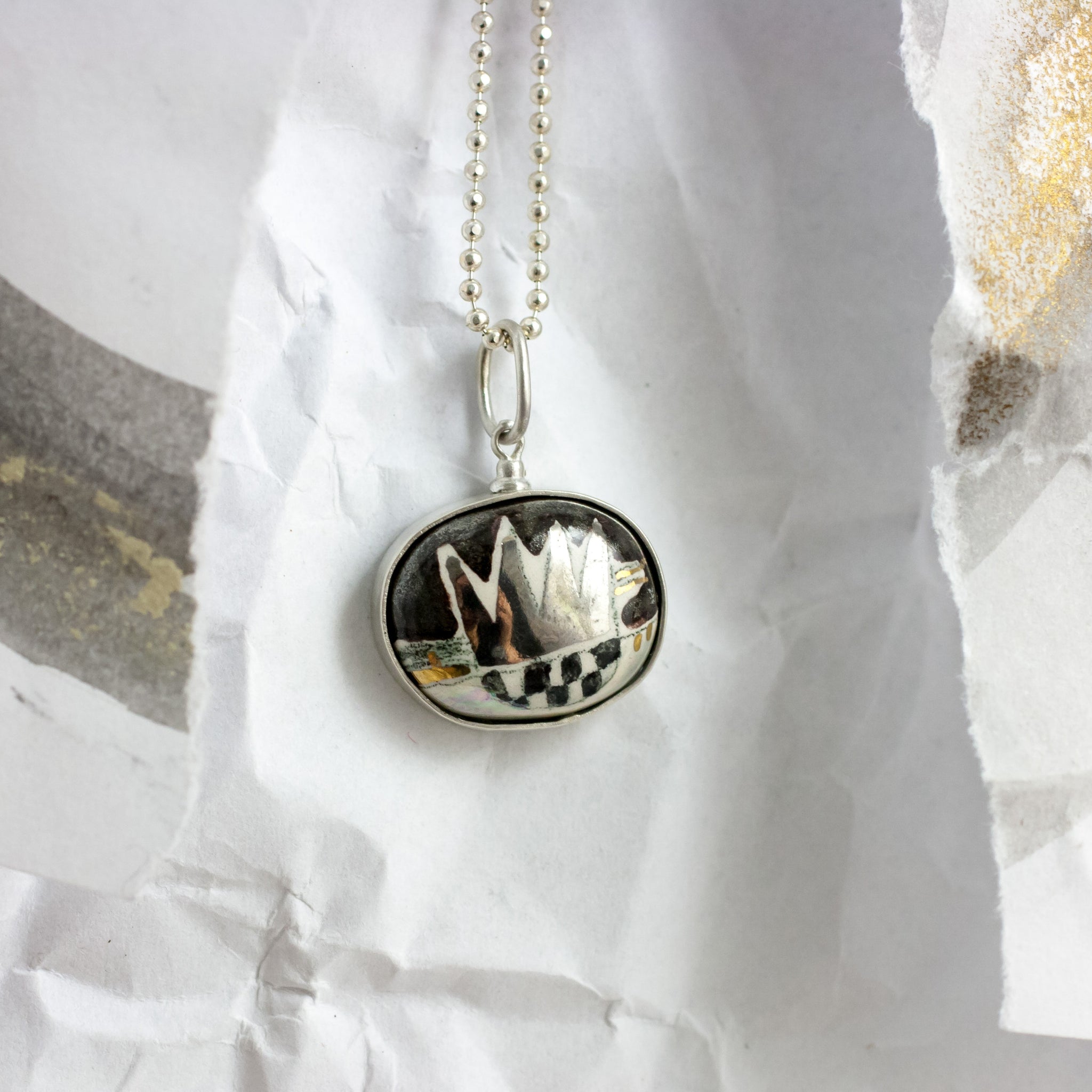 BON BON black oval form pendant with a platinum crown