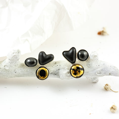 Black heart shape silver earrings with gold luster