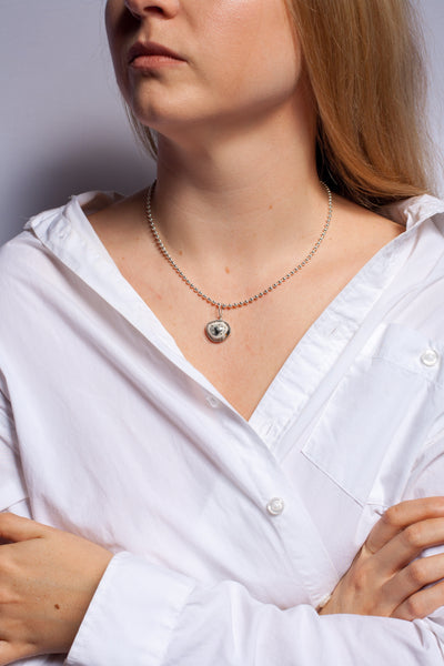 ABSTRACT black and white ceramic pendant with a platinum heart