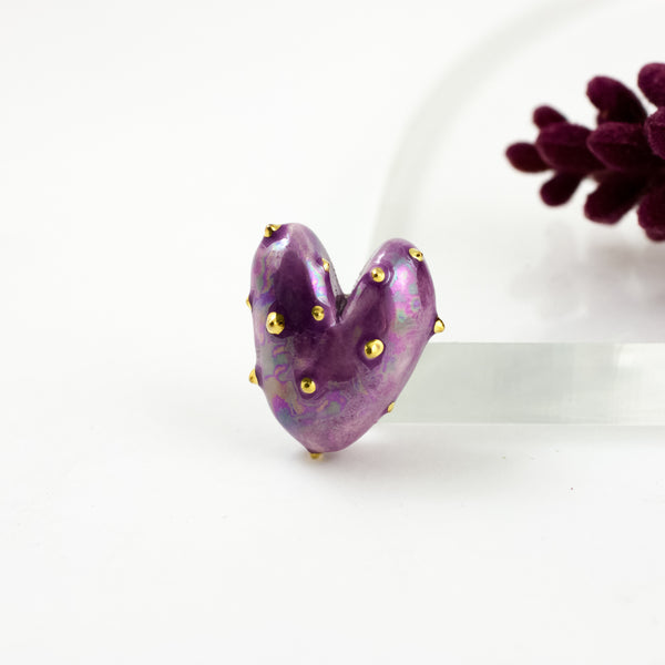 Purple heart-shaped brooch with small gold dots