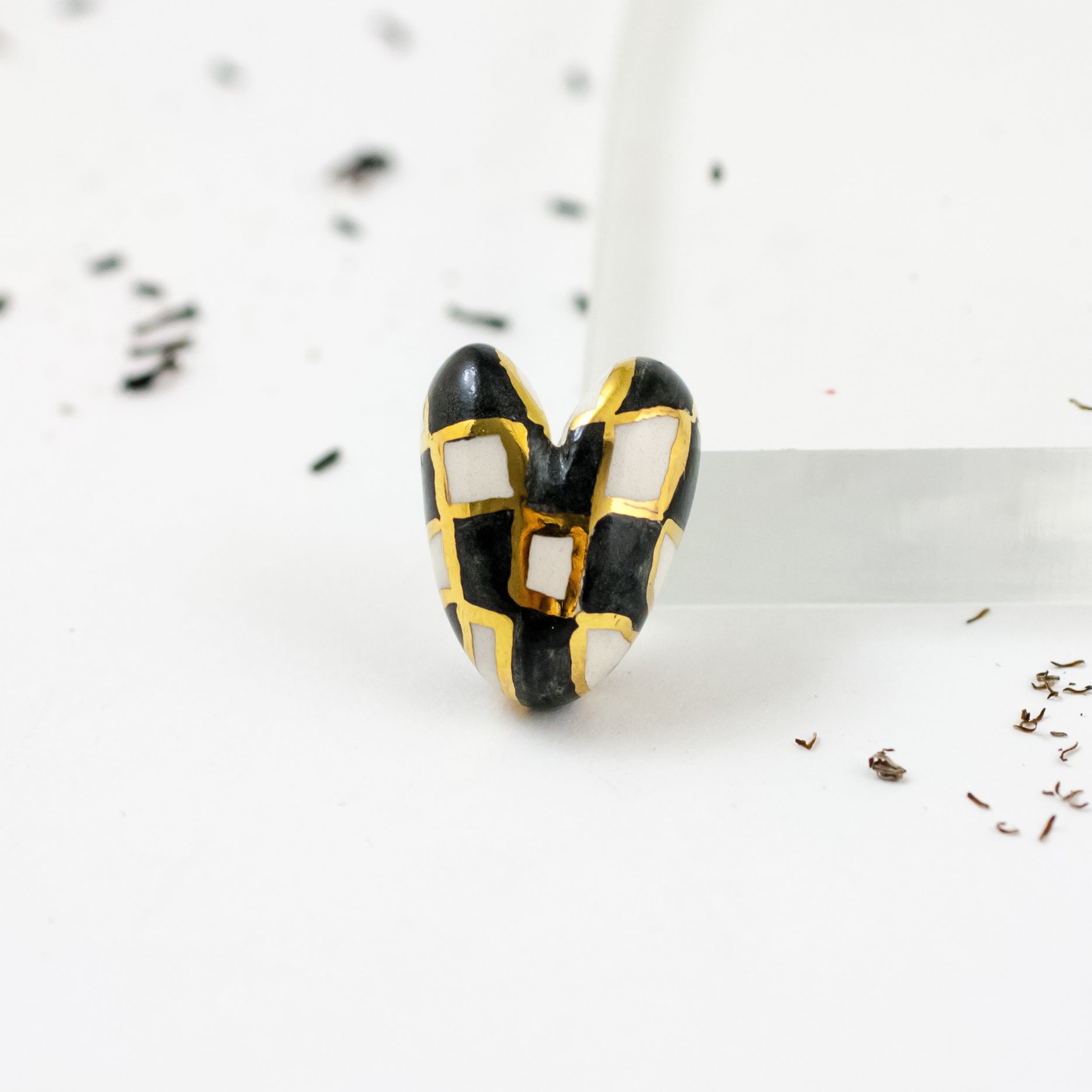 Black and white heart-shaped brooch with gold luster