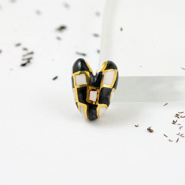 Black and white heart-shaped brooch with gold luster