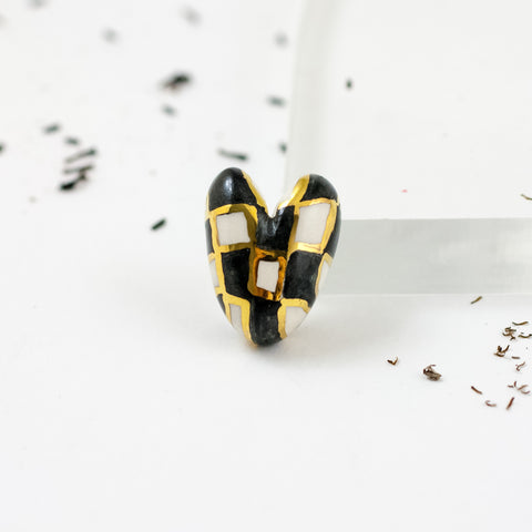 Black and white heart-shaped brooch with gold luster