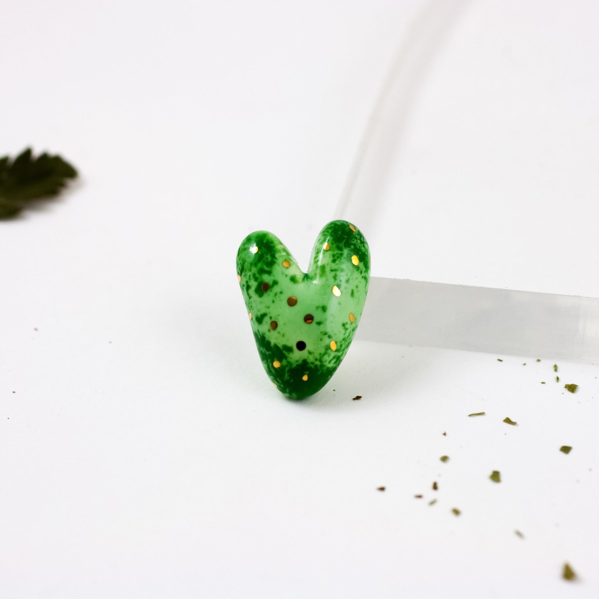 Green heart-shaped ceramic brooch with dots