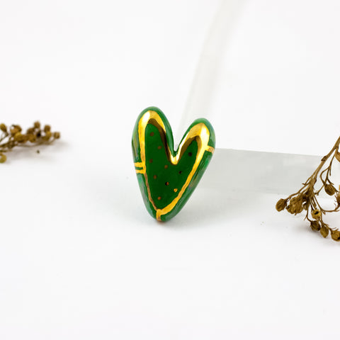 Dark green heart-shaped brooch with gold luster