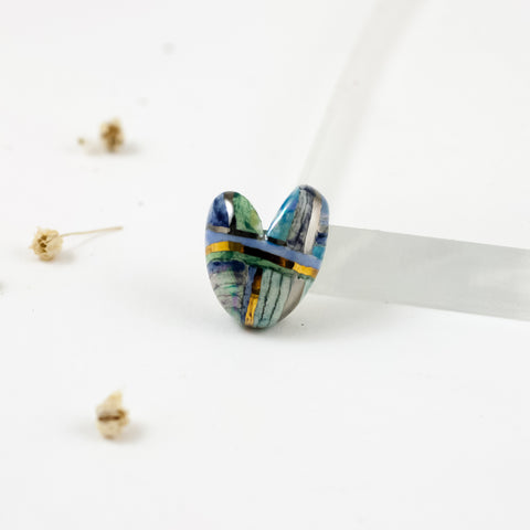 A tiny striped blue heart-shaped brooch