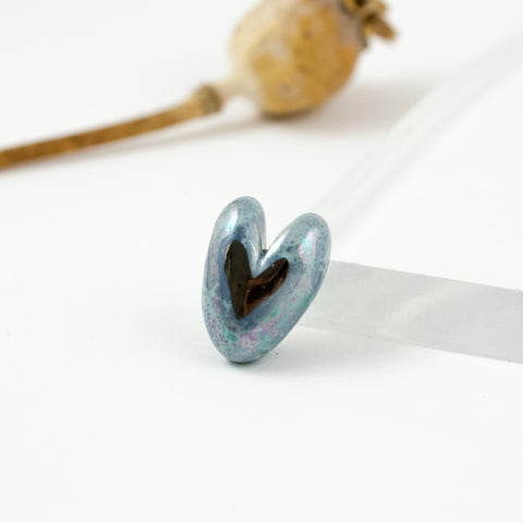 A ceramic blue heart-shaped brooch with platinum luster