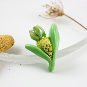 Green and yellow organic brooch with gold luster details