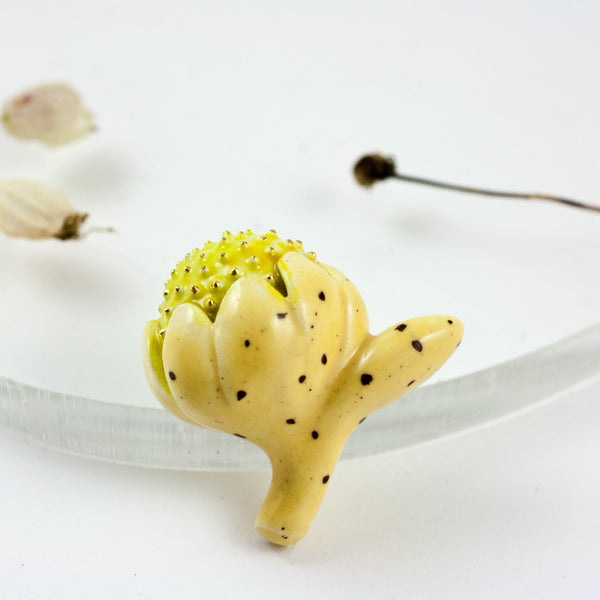 Yellow color flower bud brooch with gold dots