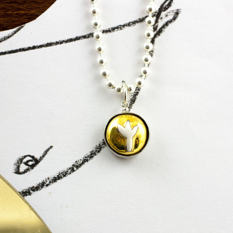 Gold color round pendant with white tulip