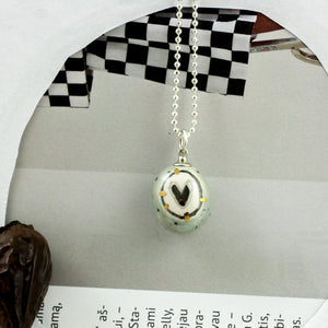 Grey BON BON pendant with a heart