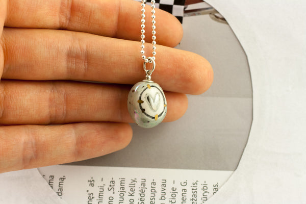 Grey BON BON pendant with a heart