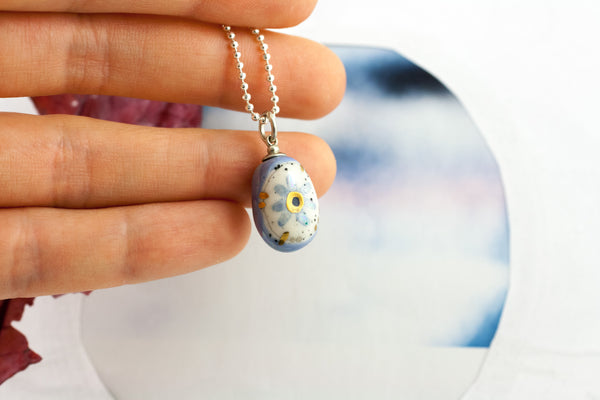 Blue oval form pendant with a flower BON BON