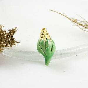 Green and yellow ceramic brooch with gold luster dots