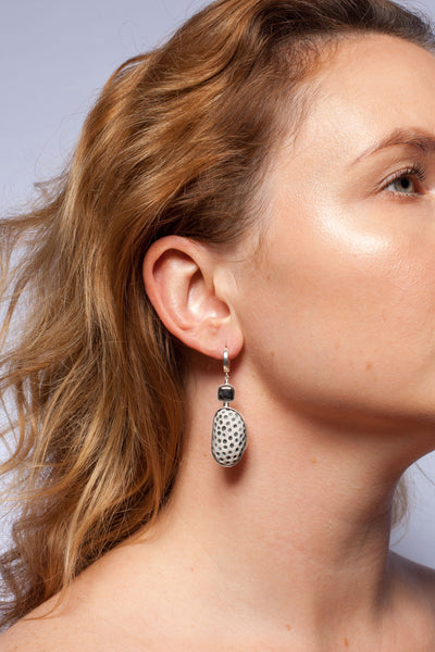 Gold and platinum plated asymmetrical earrings with black dots