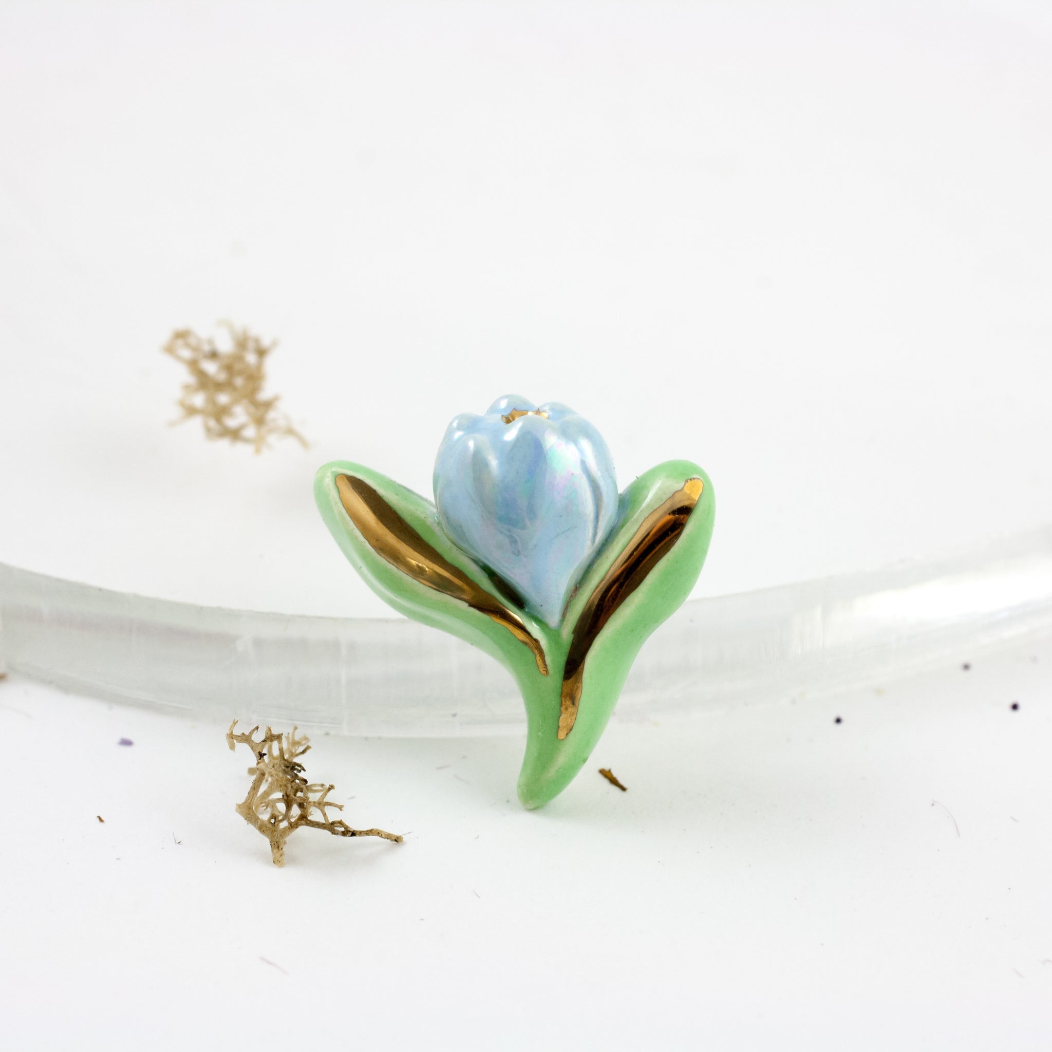 Green and blue ceramic brooch with a golden luster lines