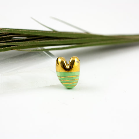 Green organic shape brooch with a golden luster lines