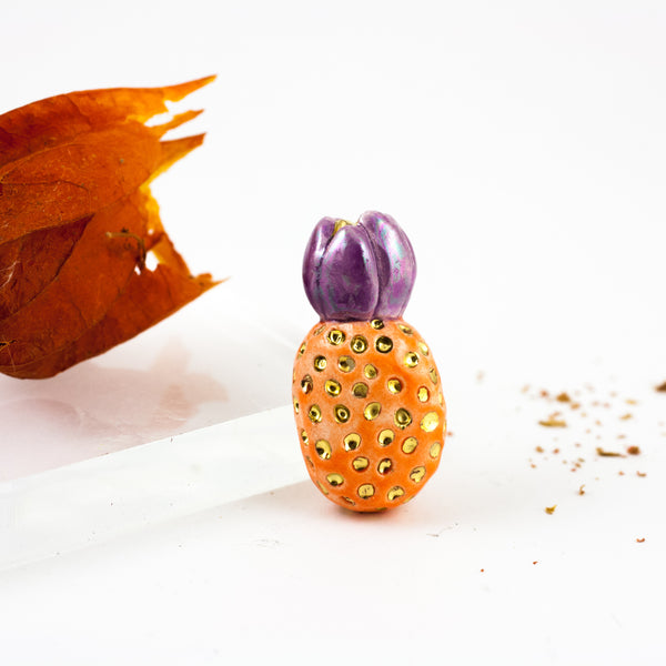 Orange and purple color brooch with gold dots