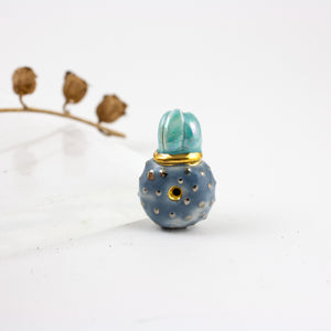 Blue and teal brooch with a platinum luster dots