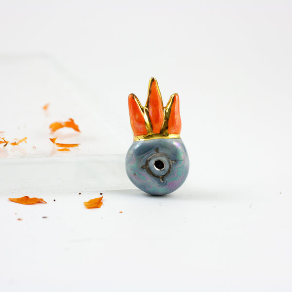 Blue brooch with an orange crown