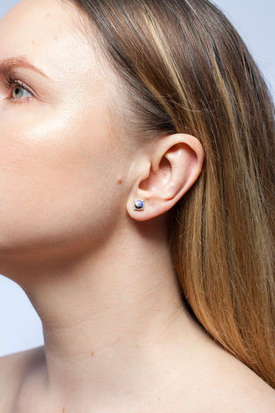 Mismatched silver stud earrings with blue ceramic details