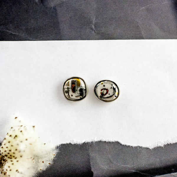 ABSTRACT Tiny earrings with fine metal luster decorated ceramics