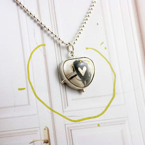 ABSTRACT White pendant with a platinum heart