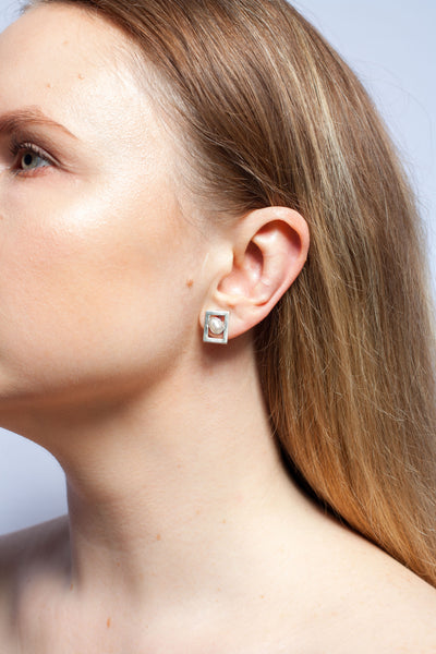 Mismatched silver stud earrings with pearls