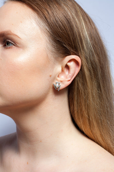 Mismatched silver stud earrings with pearls