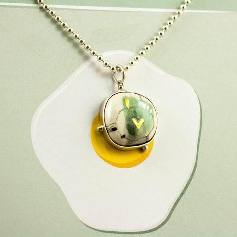 Green BON BON pendant with a gold heart