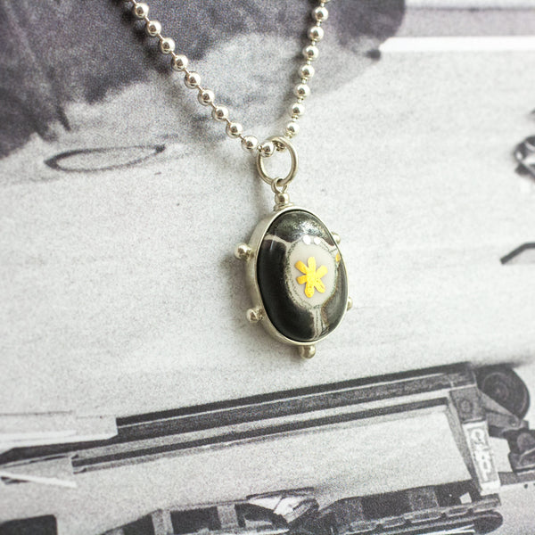 BON BON black oval form pendant with gold luster