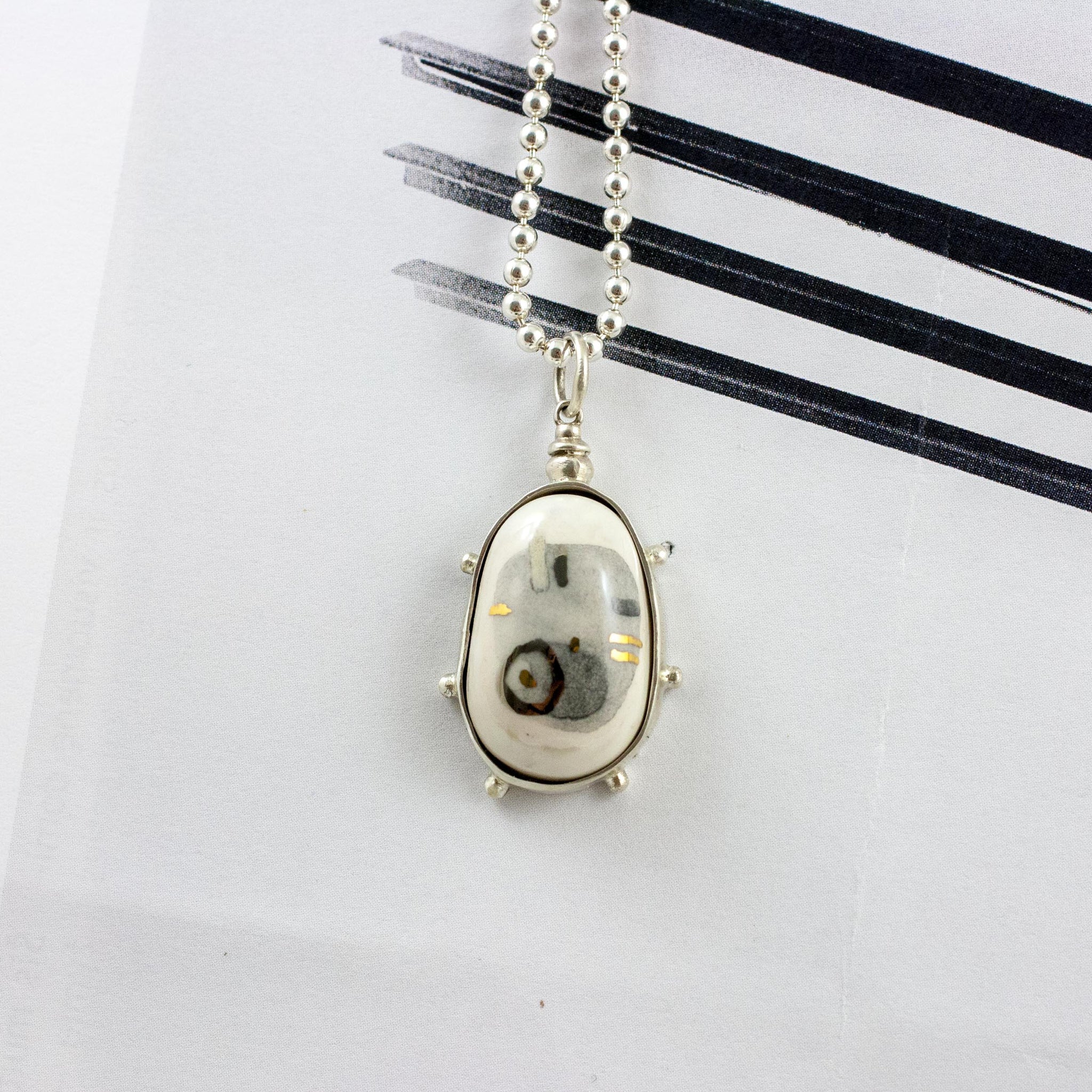 White pendant with abstract motives