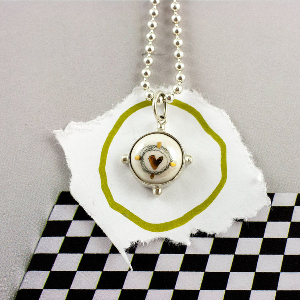 ABSTRACT White round pendant with gold details