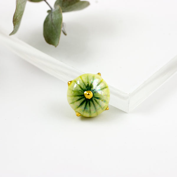 Lime green organic shape brooch with a golden luster