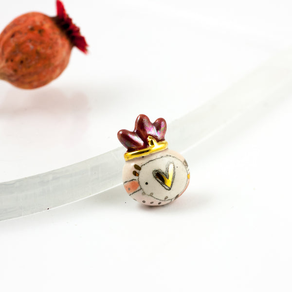 Pink brooch with burgundy crown